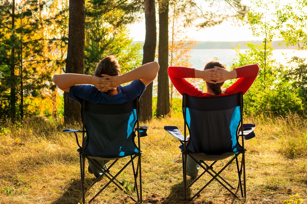 Man,And,Woman,Resting,On,The,Lake