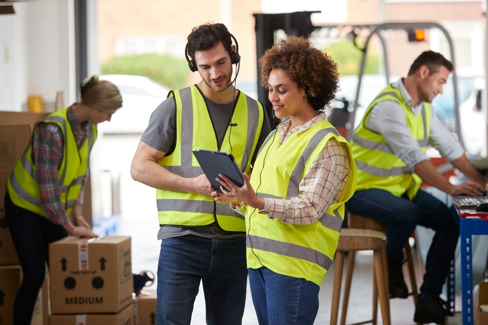 Male,And,Female,Workers,Wearing,Headsets,In,Logistics,Distribution,Warehouse