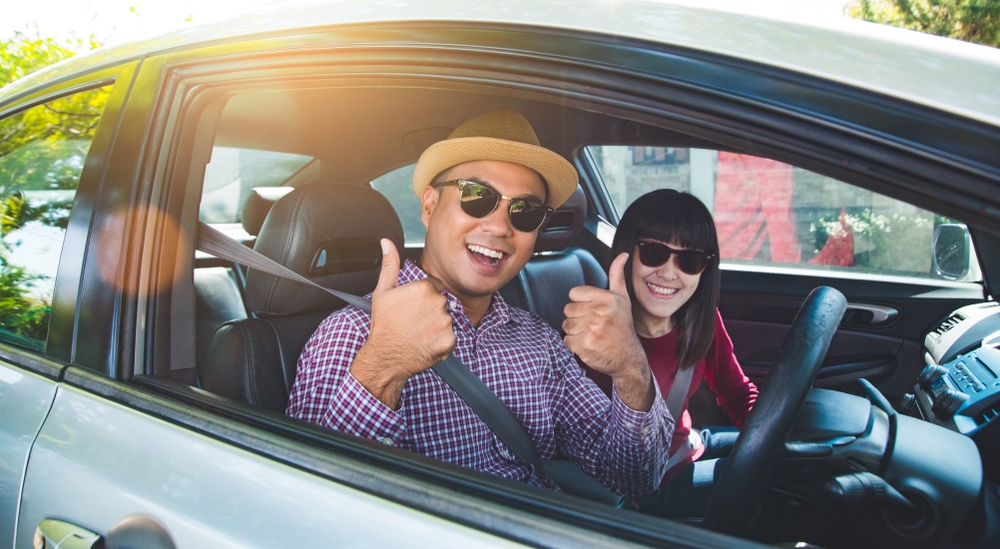 Happy moment couple asian man and woman sitting in car.