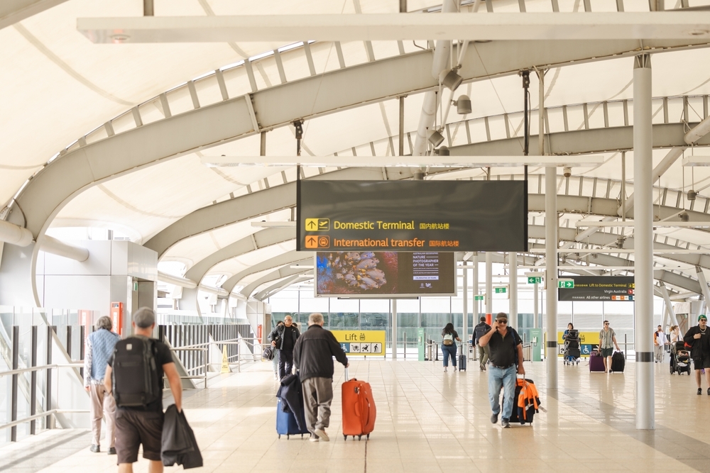 Travelers walking over the road overpass at the Brisbane Airport