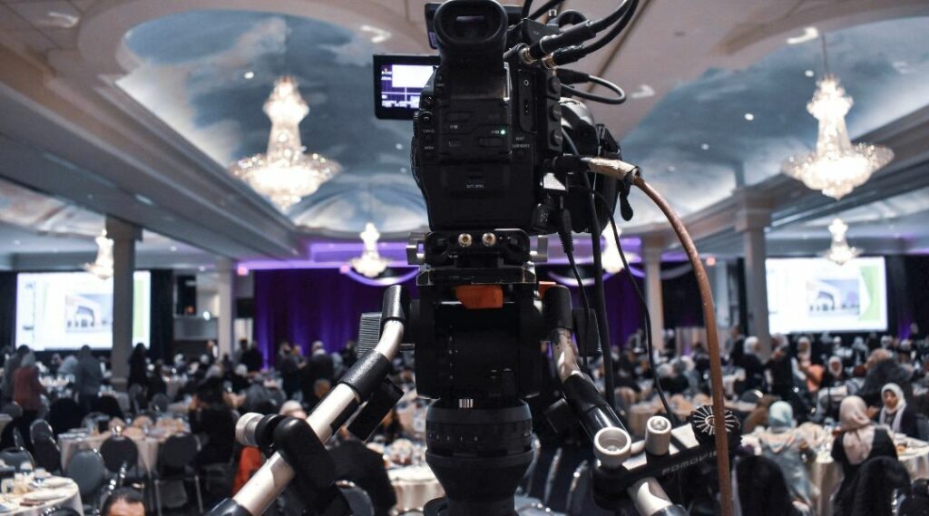 Professional video camera recording event in ballroom